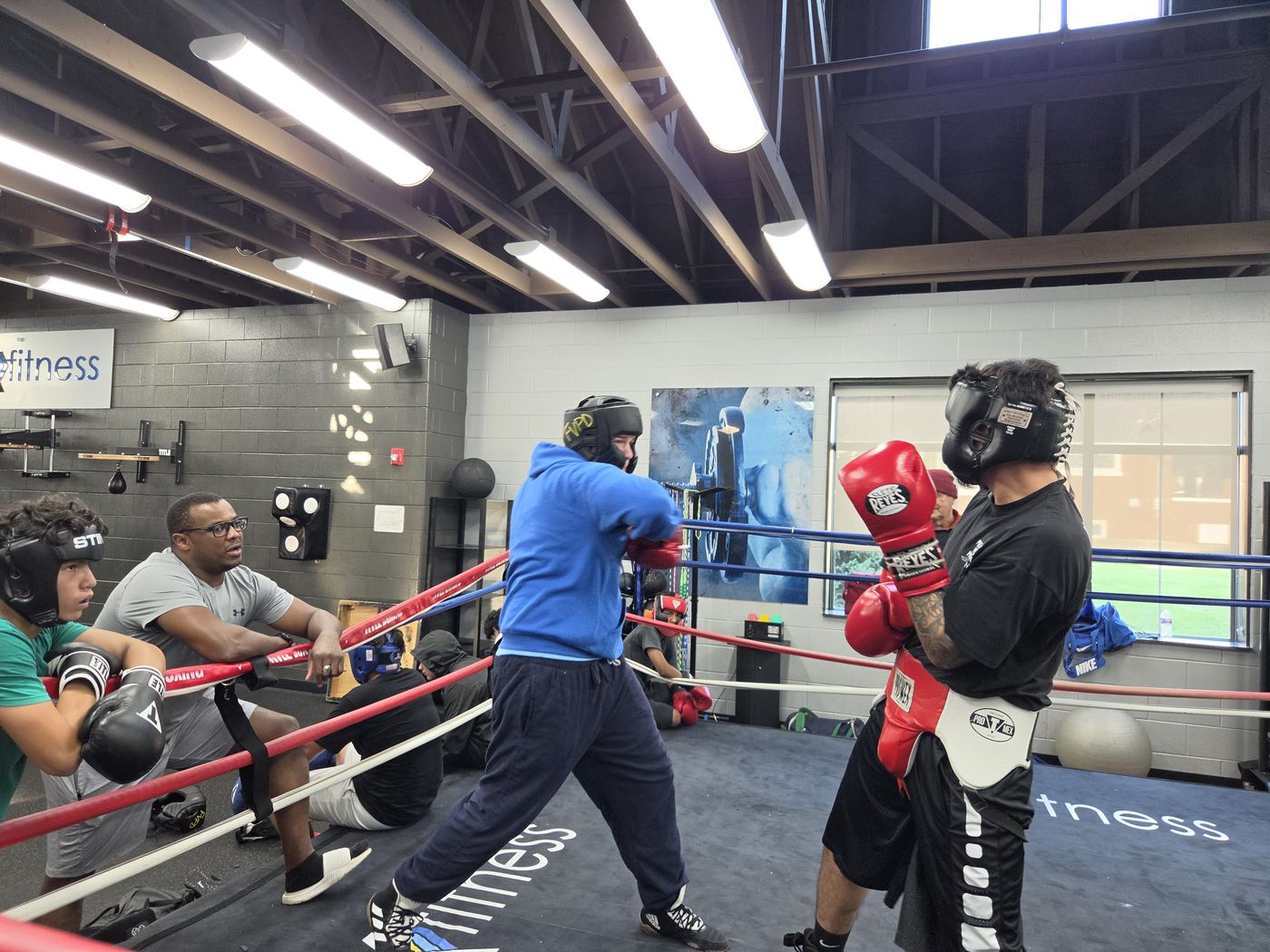 A coach holds mitts for a boxer in the Flow Boxing Academy ring